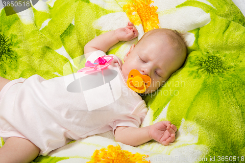 Image of Sleeping two-month girl sucking a pacifier