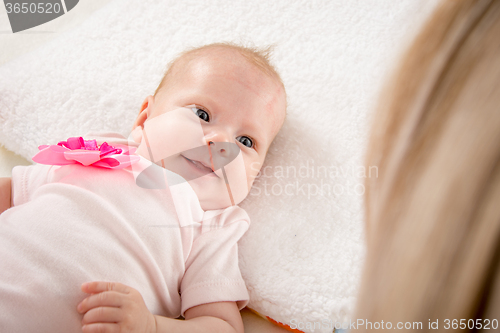 Image of Happy smiling baby looking at mother