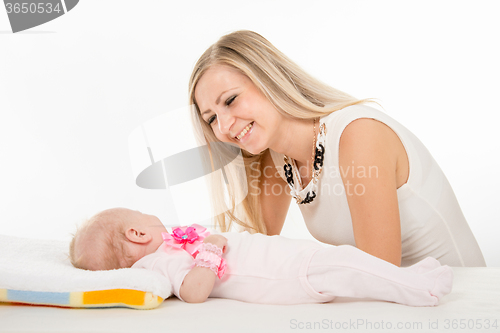 Image of Happy mother looking at a two-month daughter