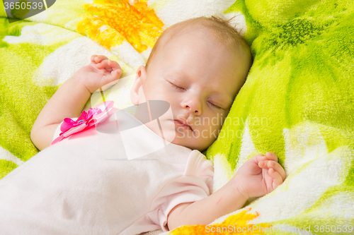 Image of The two-month baby carefree sleeping on a soft bed