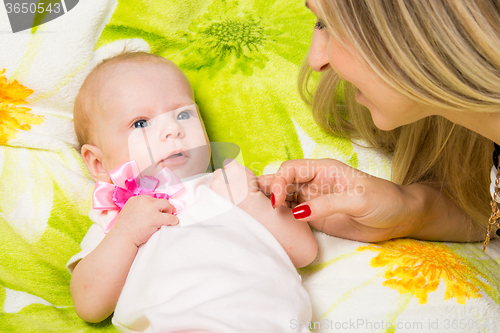 Image of My mother looks at her two month baby