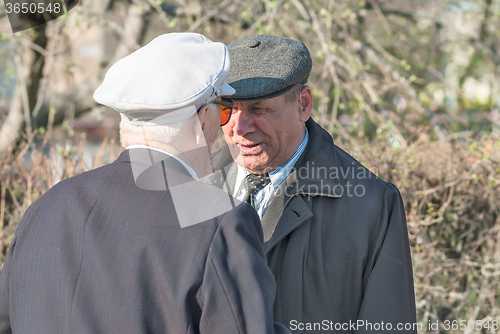 Image of Senior veterans of World War II meet on street