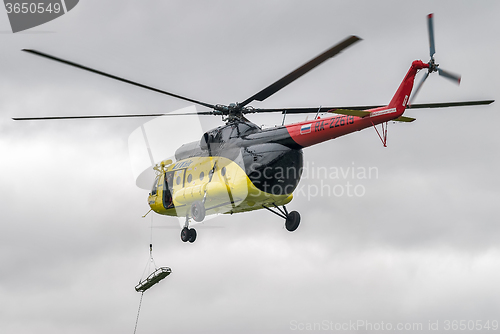 Image of Descent of empty stretcher from MI-8 helicopter