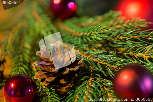 Image of fir branch with christmas ball and pinecones