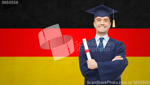 Image of smiling adult student in mortarboard with diploma