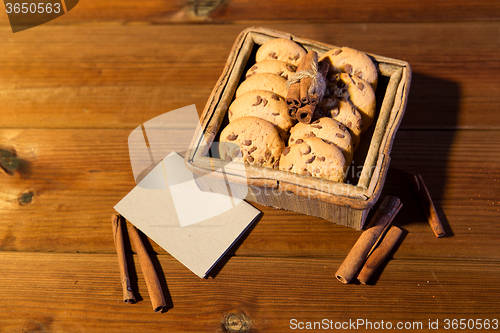 Image of close up of oat cookies and card  on wooden table