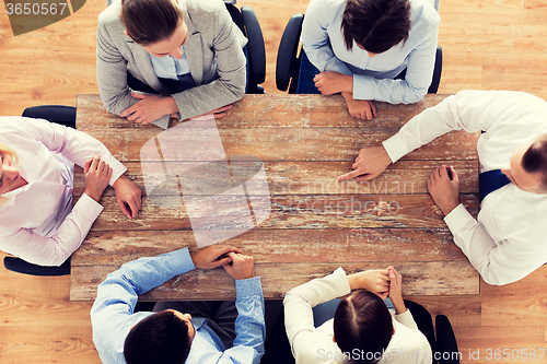 Image of close up of business team sitting at table