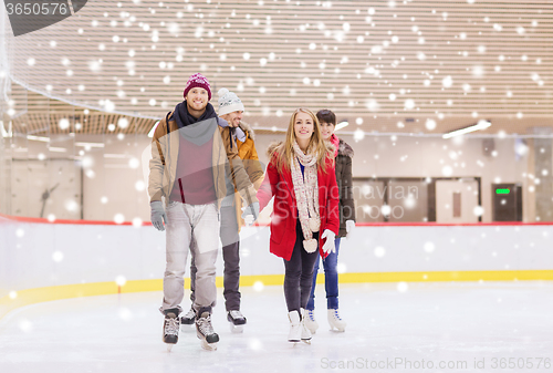 Image of happy friends on skating rink