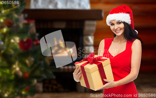 Image of beautiful sexy woman in santa hat with gift box