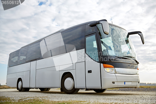 Image of tour bus driving outdoors