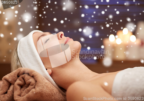 Image of close up of smiling young woman lying in spa salon