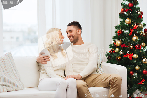 Image of happy couple at home with christmas tree