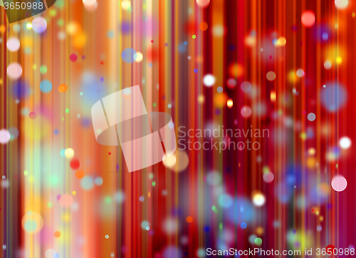 Image of confetti against a red blurred curtain background