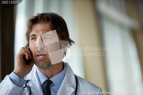 Image of doctor speaking on cellphone