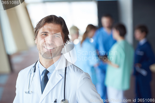 Image of group of medical staff at hospital, handsome doctor in front of 