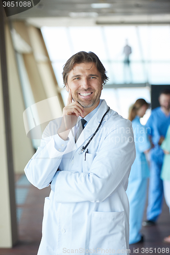 Image of group of medical staff at hospital, handsome doctor in front of 