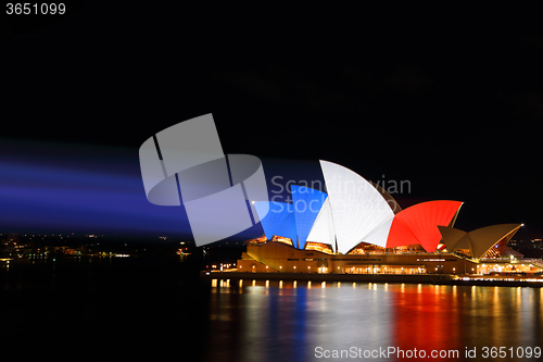 Image of Sydney Opera House lit in colours of French Flag red white blue