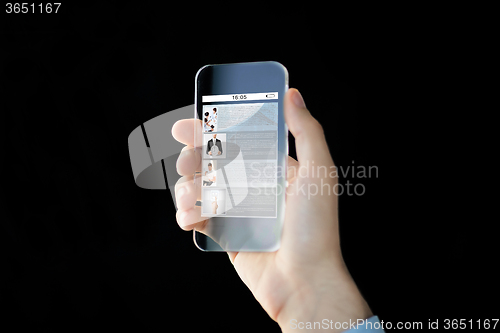 Image of close up of male hand with transparent smartphone