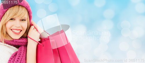 Image of smiling young woman with shopping bags