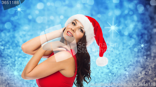 Image of beautiful sexy woman in santa hat and red dress