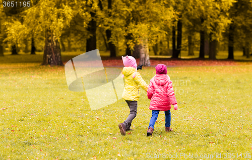 Image of happy little girls running outdoors