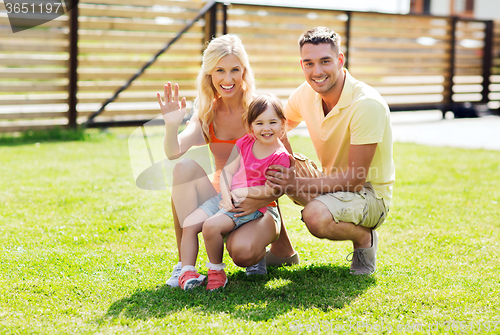 Image of happy family hugging outdoors