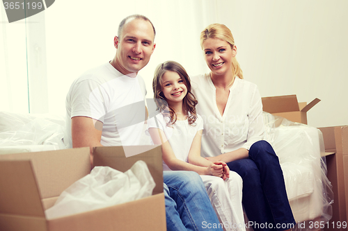 Image of happy family with boxes moving to new home