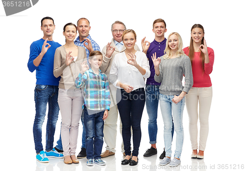 Image of group of smiling people showing ok hand sign