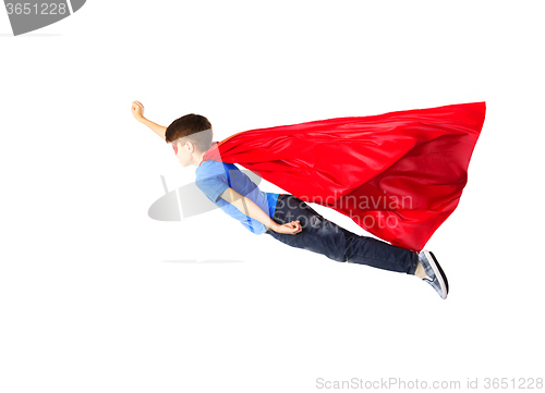 Image of boy in red superhero cape and mask flying on air