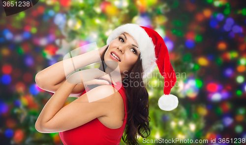 Image of beautiful sexy woman in santa hat and red dress