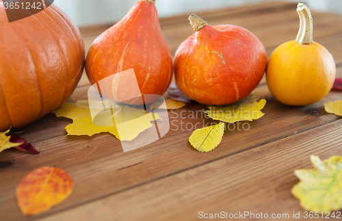 Image of close up of pumpkins on wooden table at home