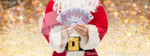 Image of close up of santa claus with euro money