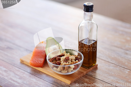 Image of close up of food and olive oil bottle on table