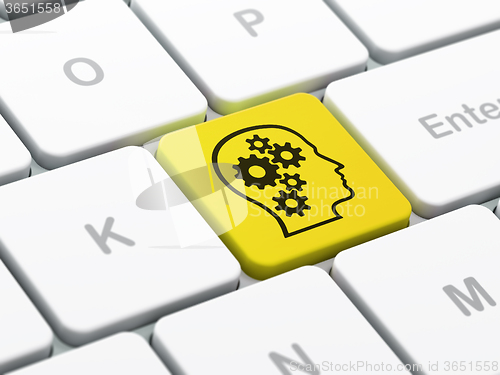 Image of Information concept: Head With Gears on computer keyboard background