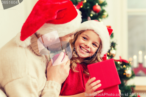 Image of smiling father and daughter opening gift box