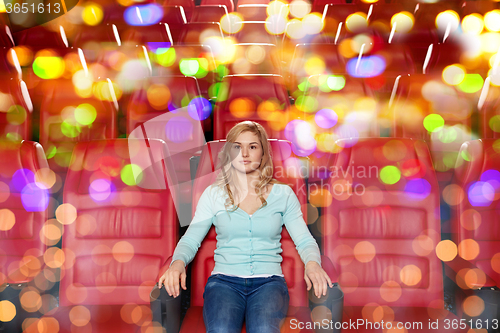 Image of young woman watching movie in theater