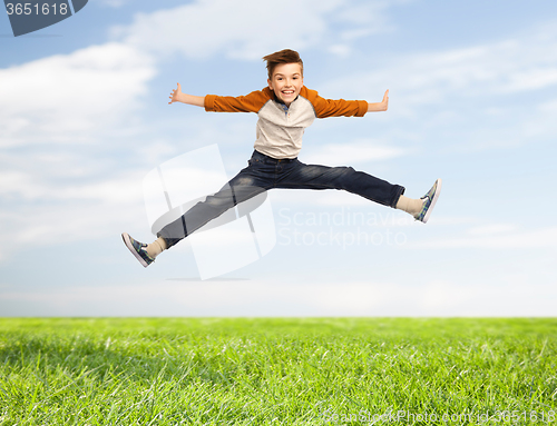 Image of happy smiling boy jumping in air