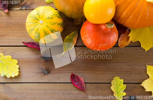 Image of close up of pumpkins on wooden table at home