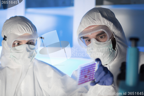 Image of close up of scientists making test in chemical lab