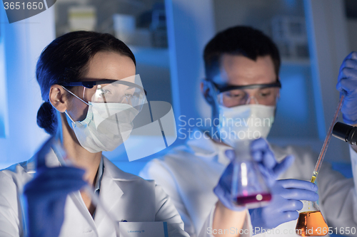 Image of close up of scientists making test in lab