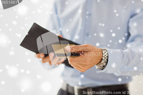 Image of close up of man holding wallet and credit card