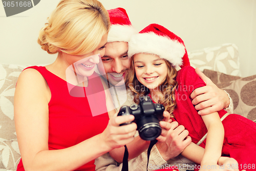 Image of family in santa helper hats looking at pictires