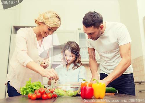 Image of happy family making dinner in kitchen