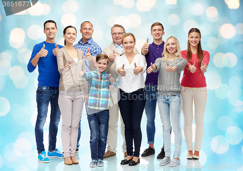 Image of group of smiling people showing thumbs up