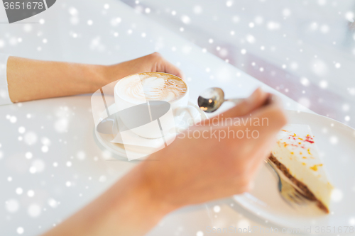 Image of close up of woman hands with cake and coffee