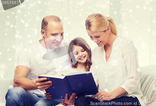 Image of happy family with book at home