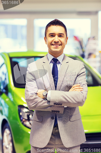 Image of happy man at auto show or car salon