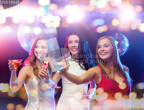 Image of smiling women with cocktails at night club