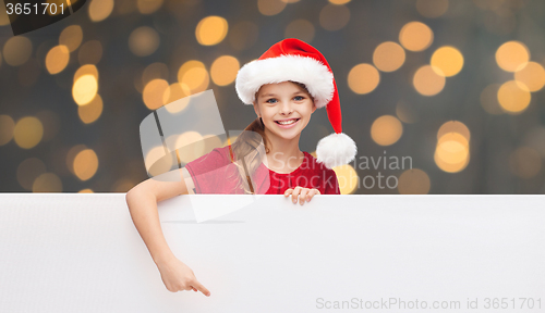 Image of child in santa helper hat with blank white board