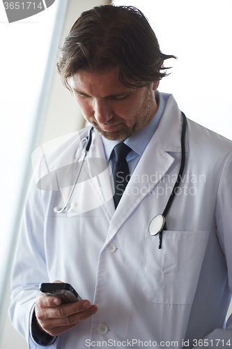 Image of doctor speaking on cellphone
